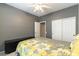 Comfortable bedroom featuring neutral walls, a ceiling fan, and a sliding door closet at 2970 Strathspey Ct, Henderson, NV 89044