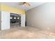 Bright bedroom features neutral walls, carpet, a ceiling fan and a peek at the connecting room at 2970 Strathspey Ct, Henderson, NV 89044
