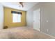 Empty room with neutral carpet, ceiling fan, and a window allowing natural light at 2970 Strathspey Ct, Henderson, NV 89044