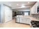 Bright kitchen with stainless steel appliances, open view to living room, and pantry door at 2970 Strathspey Ct, Henderson, NV 89044