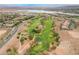 Stunning aerial view featuring a meticulously maintained golf course and a serene lake at 30 Via Vasari # 102, Henderson, NV 89011