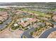 Aerial view of the community, featuring various homes, the pool area, landscaping, and a view of the lake at 30 Via Vasari # 102, Henderson, NV 89011