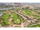 Expansive aerial view showcases the community's lush golf course, lake, and elegant residential properties at 30 Via Vasari # 102, Henderson, NV 89011