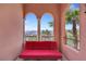 Charming balcony with a red futon and beautiful views of the surrounding landscape at 30 Via Vasari # 102, Henderson, NV 89011