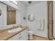 Bathroom featuring granite countertops, vanity lighting, and a glass enclosed shower at 30 Via Vasari # 102, Henderson, NV 89011