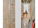 Bathroom featuring a glass enclosed shower and modern water heater at 30 Via Vasari # 102, Henderson, NV 89011