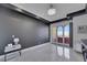 Spacious bedroom with white marble floors, dark accent wall, and access to the balcony at 30 Via Vasari # 102, Henderson, NV 89011