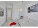 Bedroom featuring white tile floors, a white sofa, and minimalist decor at 30 Via Vasari # 102, Henderson, NV 89011