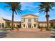 Exterior of a well-maintained community building, framed by mature palm trees and manicured landscaping at 30 Via Vasari # 102, Henderson, NV 89011