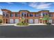 Attractive townhome complex featuring garages, neat landscaping, and an appealing architectural style with neutral paint at 30 Via Vasari # 102, Henderson, NV 89011