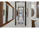 Bright hallway featuring white walls, tile floors, decorative mirrors, and framed doorways at 30 Via Vasari # 102, Henderson, NV 89011