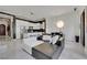 Spacious living area featuring an open floor plan, modern furnishings, and white tile flooring at 30 Via Vasari # 102, Henderson, NV 89011