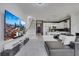 Spacious living area featuring an open floor plan, modern furnishings, and white tile flooring at 30 Via Vasari # 102, Henderson, NV 89011