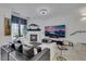 Bright living room featuring a fireplace, large TV, neutral decor and white tile flooring at 30 Via Vasari # 102, Henderson, NV 89011
