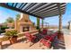 Cozy outdoor patio with a fireplace, comfortable seating, and a picturesque view at 30 Via Vasari # 102, Henderson, NV 89011