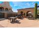 Spacious outdoor patio featuring multiple seating areas and a built-in grill, ideal for entertaining at 30 Via Vasari # 102, Henderson, NV 89011