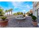 Beautiful outdoor patio with a stone fountain, lovely planters, and picturesque views of the community at 30 Via Vasari # 102, Henderson, NV 89011