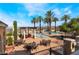 Stunning community pool area with palm trees, lounge seating, and outdoor dining spaces, perfect for relaxation at 30 Via Vasari # 102, Henderson, NV 89011