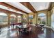The recreation room has a pool table, multiple tables, and windows offering natural light and mountain views at 30 Via Vasari # 102, Henderson, NV 89011