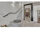 Elegant staircase with white marble steps and black accents, leading to the upper level at 30 Via Vasari # 102, Henderson, NV 89011