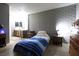 Cozy bedroom with minimalist decor, a brick accent wall, and warm natural lighting at 3008 Saint George St # B, North Las Vegas, NV 89030