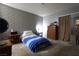 Inviting bedroom featuring a bed with cozy blanket, brick accent wall, and ample space at 3008 Saint George St # B, North Las Vegas, NV 89030