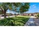 Well-manicured front lawn with mature trees and ample greenery at 3008 Saint George St # B, North Las Vegas, NV 89030