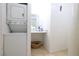 Efficient laundry area features a stacked washer and dryer at 3008 Saint George St # B, North Las Vegas, NV 89030