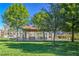 Scenic park grounds with lush green grass, mature trees, and a covered picnic area by the lake at 3104 Waterview Dr, Las Vegas, NV 89117