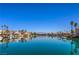 Beautiful view of luxurious lakeside homes and boats docked along the tranquil, reflective water at 3104 Waterview Dr, Las Vegas, NV 89117