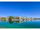 Stunning waterfront homes reflecting beautifully in the clear, serene lake on a bright day at 3104 Waterview Dr, Las Vegas, NV 89117