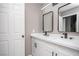 Bathroom featuring double sink vanity, quartz countertop, matte black fixtures, and a door at 3105 Birch Hill Ct, Las Vegas, NV 89134