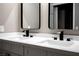 Bathroom features dual sinks with black hardware and frameless rectangular mirrors at 3105 Birch Hill Ct, Las Vegas, NV 89134