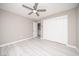 Bedroom has whitewashed floors, a ceiling fan, and sliding door access to closet and bath at 3105 Birch Hill Ct, Las Vegas, NV 89134