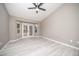 Bedroom offers patio access via french doors, whitewashed floors, and neutral color palette at 3105 Birch Hill Ct, Las Vegas, NV 89134