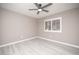 Bedroom features a ceiling fan, whitewashed floors, and a window with privacy shutters at 3105 Birch Hill Ct, Las Vegas, NV 89134