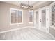 Bright dining area with white shutters, a modern light fixture, and light grey flooring at 3105 Birch Hill Ct, Las Vegas, NV 89134