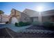 Single-story home showcasing desert landscaping, a tile roof, and a two-car garage with a lengthy driveway at 3105 Birch Hill Ct, Las Vegas, NV 89134