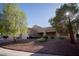 Single-story home showcases desert landscaping and mature trees along with a tile roof and a two-car garage at 3105 Birch Hill Ct, Las Vegas, NV 89134