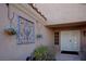Attractive home entry with decorative wall hangings and a white double-door entry, framed by desert landscaping at 3105 Birch Hill Ct, Las Vegas, NV 89134