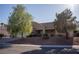 Single-story home showcasing desert landscaping and a tile roof, complemented by mature trees and a two-car garage at 3105 Birch Hill Ct, Las Vegas, NV 89134