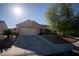 Single-story home with a desert landscaped front yard and a two-car garage with a paved driveway at 3105 Birch Hill Ct, Las Vegas, NV 89134
