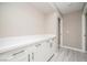 Hallway with white cabinets and a countertop; light grey flooring and access to other rooms at 3105 Birch Hill Ct, Las Vegas, NV 89134
