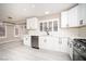 Well-lit kitchen features gray flooring, white cabinets, and stainless-steel appliances at 3105 Birch Hill Ct, Las Vegas, NV 89134