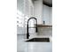 Modern kitchen boasts white countertops, black hardware, and white subway tile backsplash at 3105 Birch Hill Ct, Las Vegas, NV 89134
