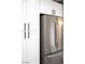 Modern kitchen features white cabinets, pantry and stainless-steel refrigerator at 3105 Birch Hill Ct, Las Vegas, NV 89134