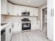 Bright kitchen features white cabinets, modern stainless-steel appliances, and gray flooring at 3105 Birch Hill Ct, Las Vegas, NV 89134