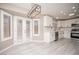 Open kitchen and dining area with white cabinets, stainless steel appliances, and grey wood flooring at 3105 Birch Hill Ct, Las Vegas, NV 89134