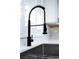 Close-up of a modern matte black kitchen sink with a spring faucet and stainless steel sink at 3105 Birch Hill Ct, Las Vegas, NV 89134