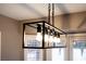 Modern light fixture with five bulbs over the dining area with white shutters at 3105 Birch Hill Ct, Las Vegas, NV 89134